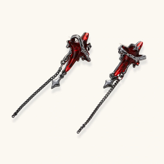 Gothic red resin dagger earrings with silver chain details and S925 posts on white background