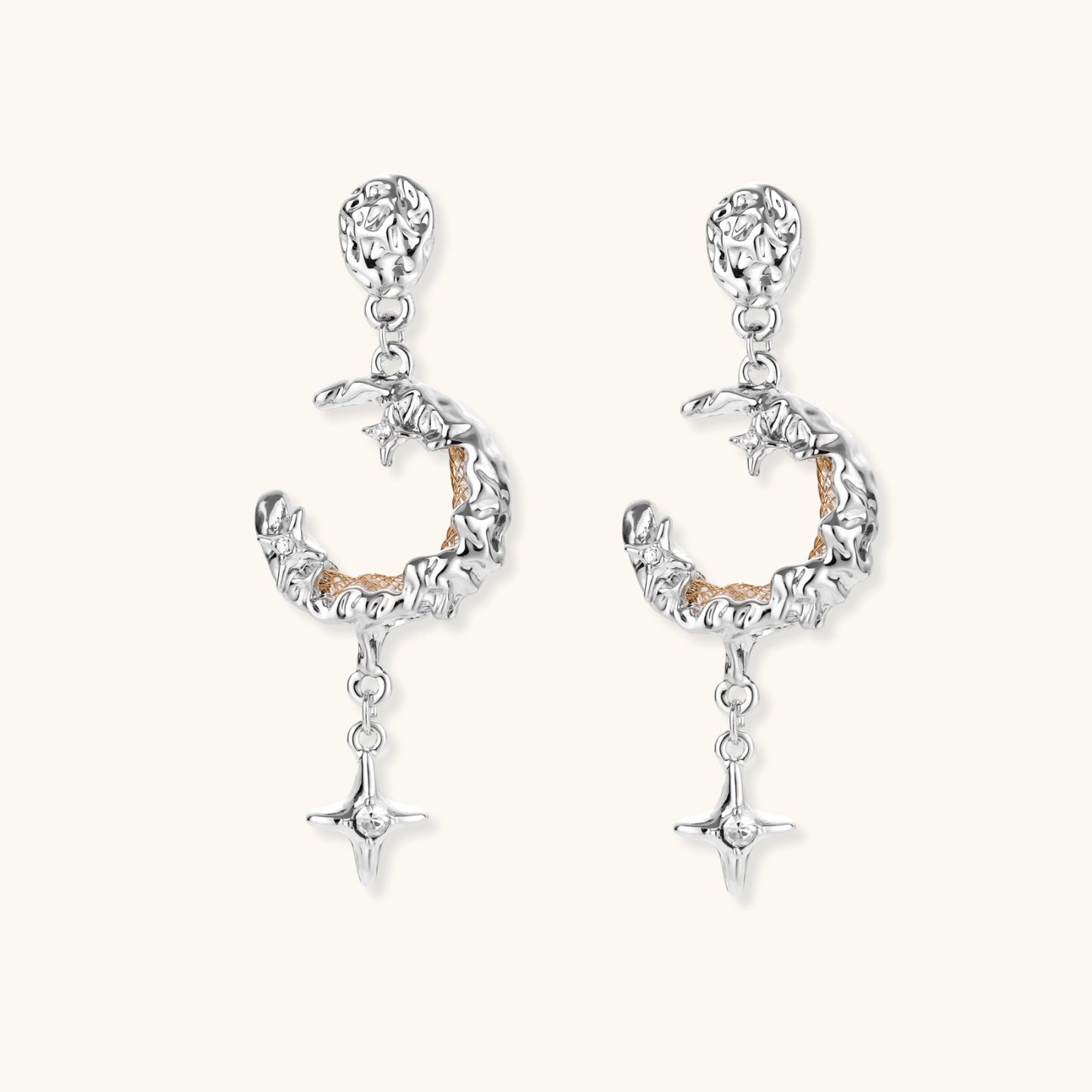 Detailed eco-brass dangle earrings featuring crescent moons with gold rope details and dangling star charms on white background.