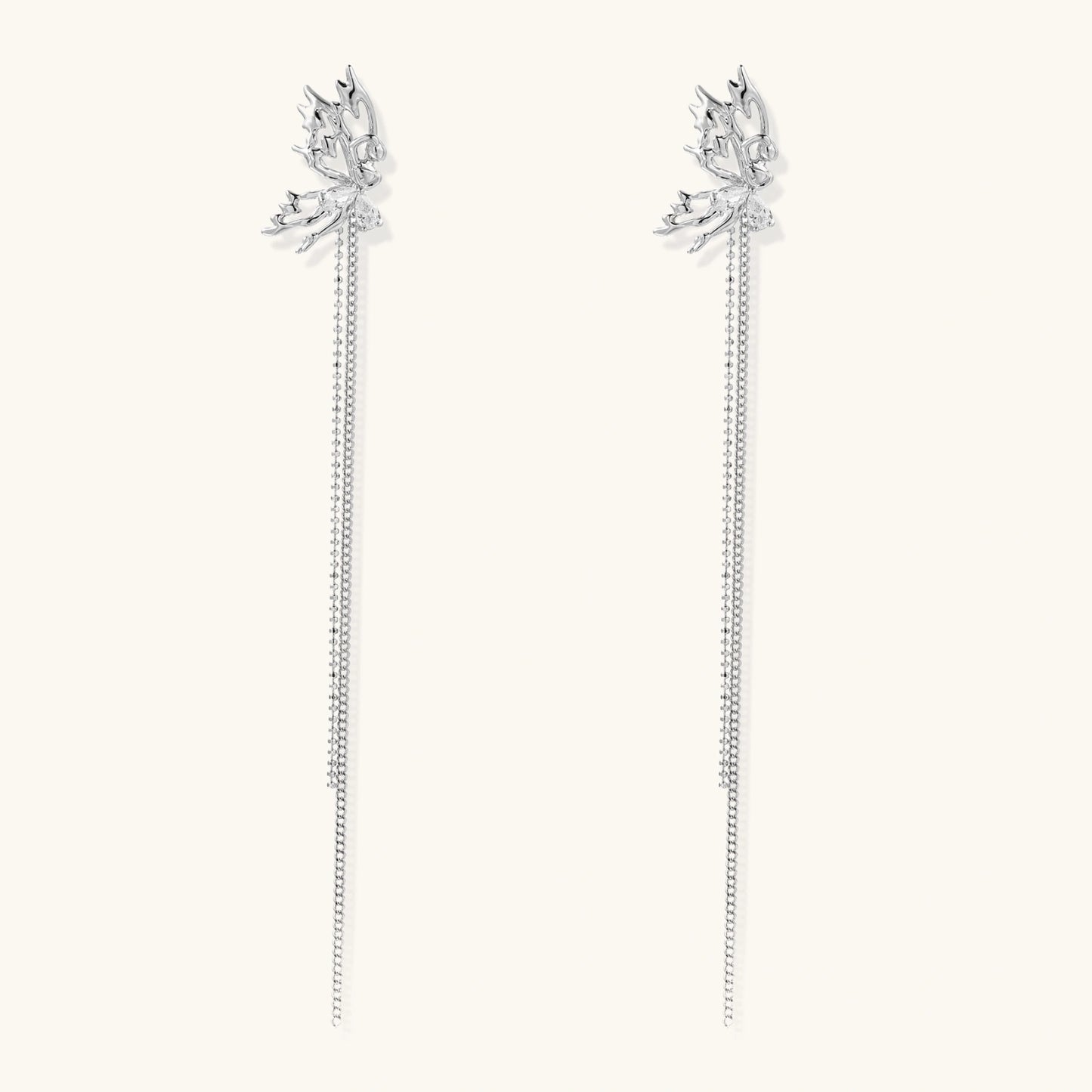 Silver-toned threader earrings featuring detailed fairy figure with wings and dual delicate chain strands, zirconia accents