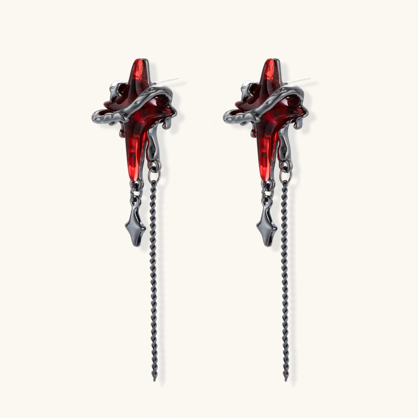 Gothic red resin dagger earrings with silver chain details and S925 posts on white background