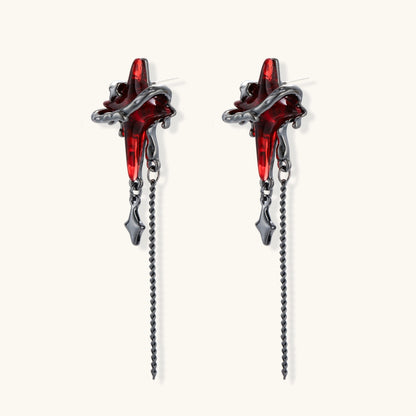 Gothic red resin dagger earrings with silver chain details and S925 posts on white background