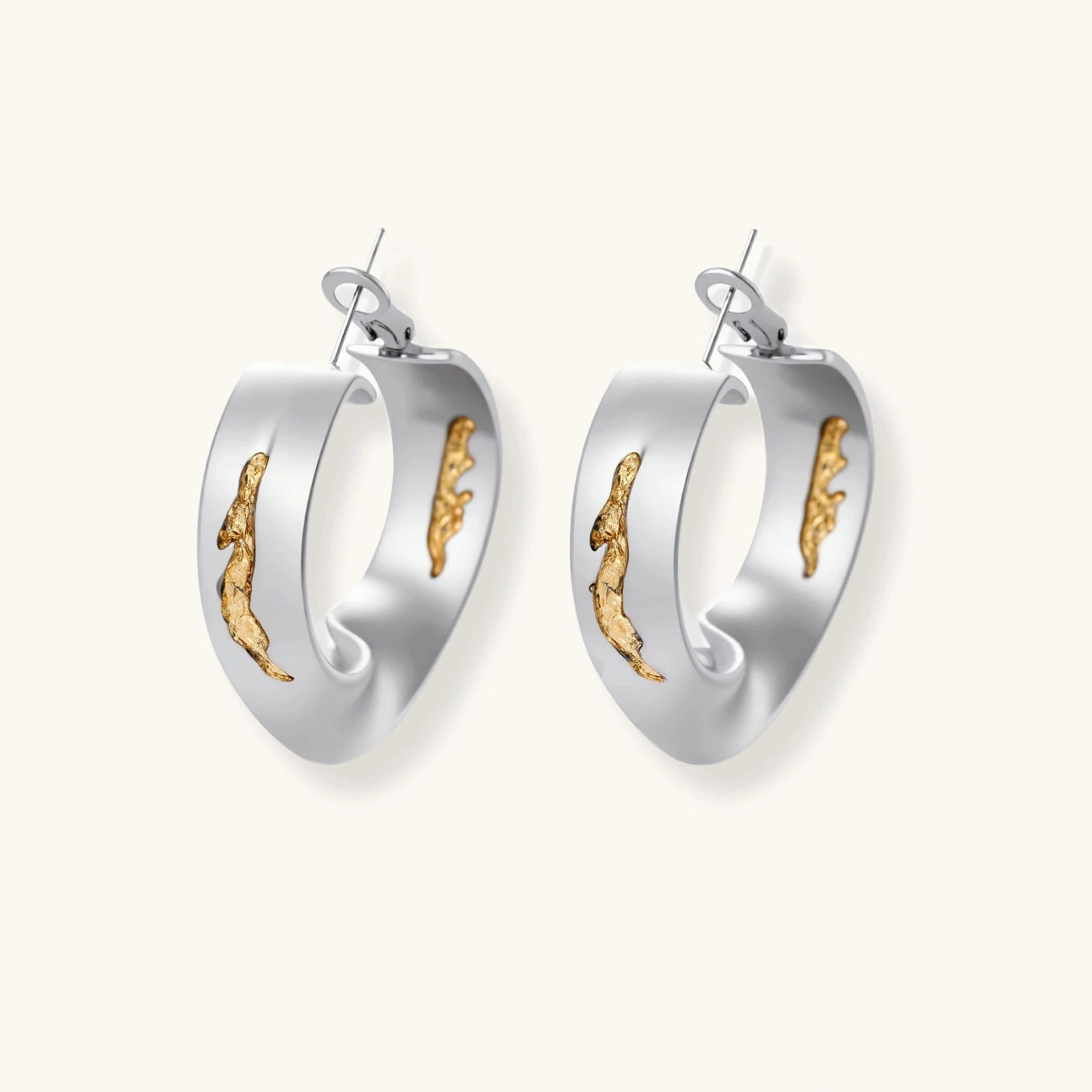 Artistic jewelry set featuring curved silver pendant with gold veining on black cord plus matching asymmetrical hoop earrings