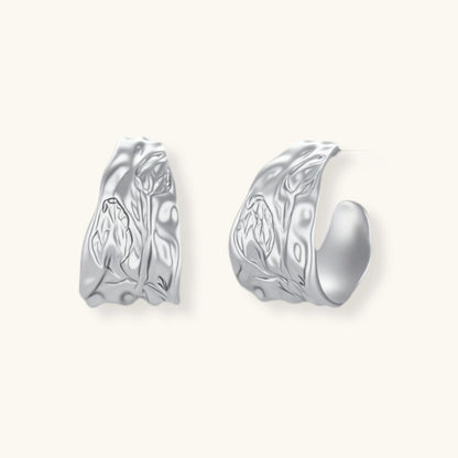Textured silver jewelry set with floral engravings featuring adjustable cord necklace and matching hoop earrings