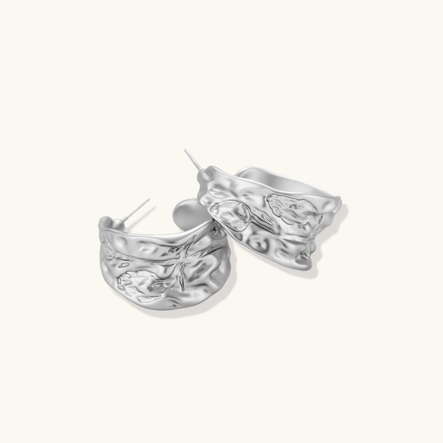 Textured silver jewelry set with floral engravings featuring adjustable cord necklace and matching hoop earrings