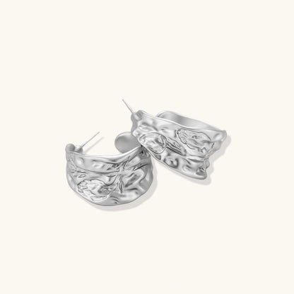 Textured silver jewelry set with floral engravings featuring adjustable cord necklace and matching hoop earrings