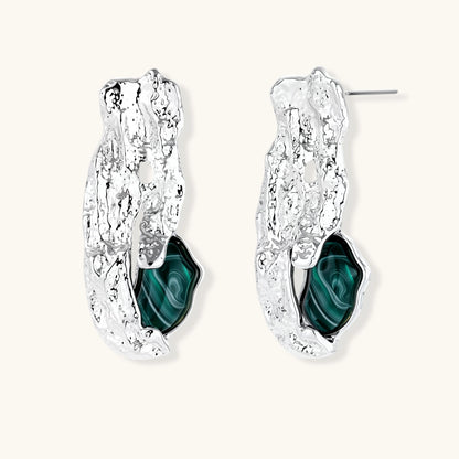 Organic-shaped stud earrings with hammered silver finish and green malachite-pattern resin stones on white background.
